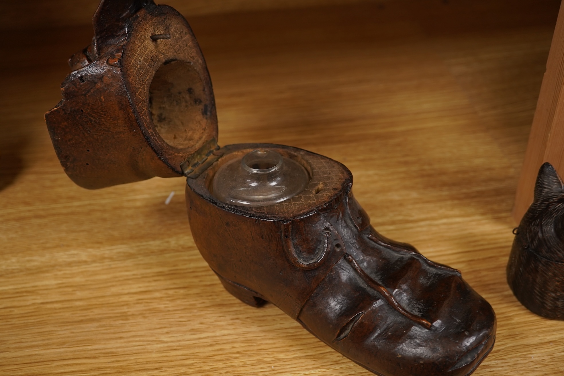 A Black Forest carving of a kitten in a boot inkwell and another car inkwell, tallest 15cm